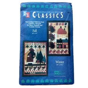 May include: A blue package with two patchwork patterns for Autumn and Winter. The Fall pattern is 61 x 94 cm, and the Winter pattern is 61 x 85 cm. The package includes text that reads "2 in 1 Classics".