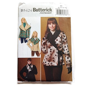 May include: A Butterick B5424 sewing pattern envelope featuring illustrations of wrap jackets with large collars. The designs include a plaid version, a solid tan version, and a leopard print version with a black collar and tie closure.