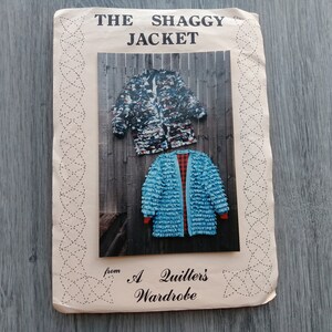 May include: A sewing pattern envelope titled THE SHAGGY JACKET from A Quilter's Wardrobe. The cover features a photograph of two jackets: one with a multi-coloured textured pattern and another in bright blue with a red interior lining.