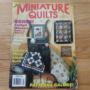 May include: A magazine cover titled "Miniature Quilts" with the text "Patterns Galore!" features images of miniature quilts, a small cabinet, and a cat figurine. The cover includes the text "Bonus! Contest Winners" and "Create a Photo Album Quilt".