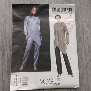 May include: A Vogue Patterns sewing pattern envelope for Tom and Linda Platt designs, featuring illustrations of a long-sleeved tunic with an asymmetrical hem and straight-leg trousers. The envelope includes pattern number 2577 and size range 14, 16, 18.