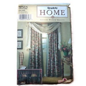 May include: A Simplicity Home sewing pattern envelope, number 8052, for Country Window Dressing. The package features illustrations of floral curtains with a crocheted valance and a secondary image of dark curtains with a ruffled valance design.