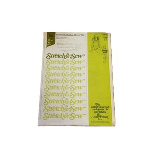 May include: A rectangular sewing pattern envelope for a Children's Raglan Sleeve Top, pattern number 862. The cover features the Stretch & Sew logo repeated in green text on a white background, with a lime green side panel and line art illustrations.