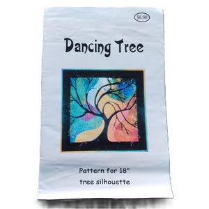 May include: A white paper pattern titled "Dancing Tree" with a colorful tree silhouette design. The tree is set within a square frame with a black border. The pattern is for an 18-inch tree silhouette.