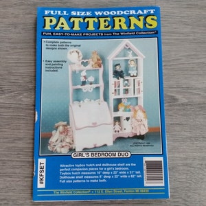 May include: A blue and white book cover titled "FULL SIZE WOODCRAFT PATTERNS" featuring a toybox hutch and dollhouse shelf design. The text "GIRL'S BEDROOM DUO" is also visible. The toybox hutch measures 16" deep x 22" wide x 51" tall.