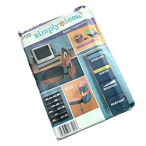 May include: A Simplicity 5133 Simply Teen sewing pattern envelope for room organizers. The packaging features illustrations of fabric storage pockets for chairs, desks, and walls, with labels for English, Math, Science, and History subjects.