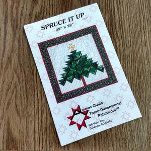 May include: A quilt pattern titled "SPRUCE IT UP" featuring a Christmas tree design. The pattern is 29" x 29" and includes a green and red border. The pattern is from "nimas Quilts Three-Dimensional Patchwork™".