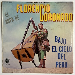 May include: Album cover featuring a man playing a harp. The album title is "Florencia Coronado" in yellow letters. The text "Bajo El Cielo Del Peru" is in blue. The man is wearing a colorful traditional outfit.