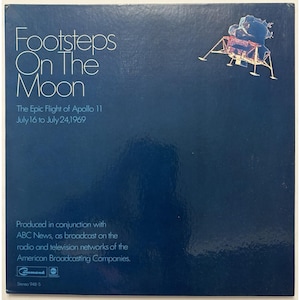 May include: A dark blue album cover with the title "Footsteps On The Moon" in white. The text "The Epic Flight of Apollo 11 July 16 to July 24,1969" is also visible. A graphic of the Apollo 11 lunar module is in the upper right corner.