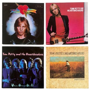 May include: Four Tom Petty and the Heartbreakers vinyl record covers. Top left features a heart and guitar graphic. Top right shows Tom Petty with a guitar. Bottom left displays the band members. Bottom right depicts a field with a person.