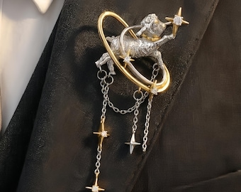 Celestial Creature and Star Chain Brooch Intricate Orbiting Figure Pin with Dangling Star Accents