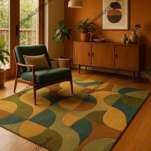 May include: A patterned rug in a living room setting, featuring a design of overlapping shapes in green, gold, and brown. The rug sits on a wooden floor, with a green armchair and a wooden cabinet visible. The room has a warm, inviting feel.