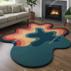 May include: An abstract, organically shaped rug in a living room. The rug has a colour gradient of red, orange, yellow, and teal. It is placed on a wooden floor. The rug's shape is reminiscent of a flowing form.