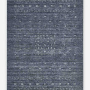 May include: A rectangular, indigo blue area rug with a geometric pattern. The rug features rows of white diamond and rectangular shapes, along with dotted lines and decorative symbols. The central design is a square with a grid of white dots.
