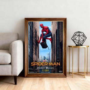 May include: Framed movie poster for Spider-Man: Homecoming, featuring the superhero in a red and blue suit. The poster has a wooden frame and includes the movie title and release date.