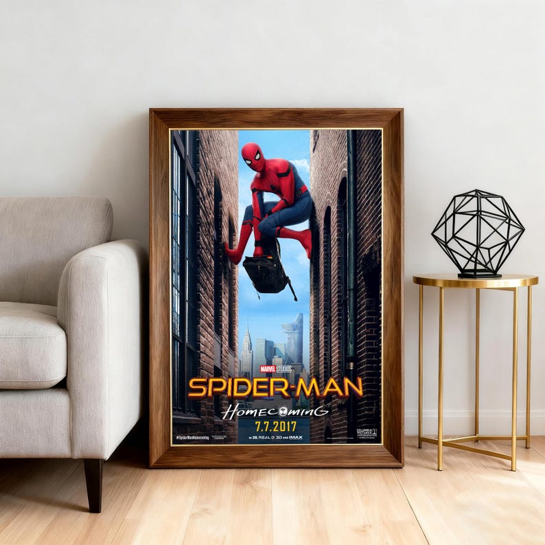 May include: Framed movie poster for Spider-Man: Homecoming, featuring the superhero in a red and blue suit. The poster has a wooden frame and includes the movie title and release date.
