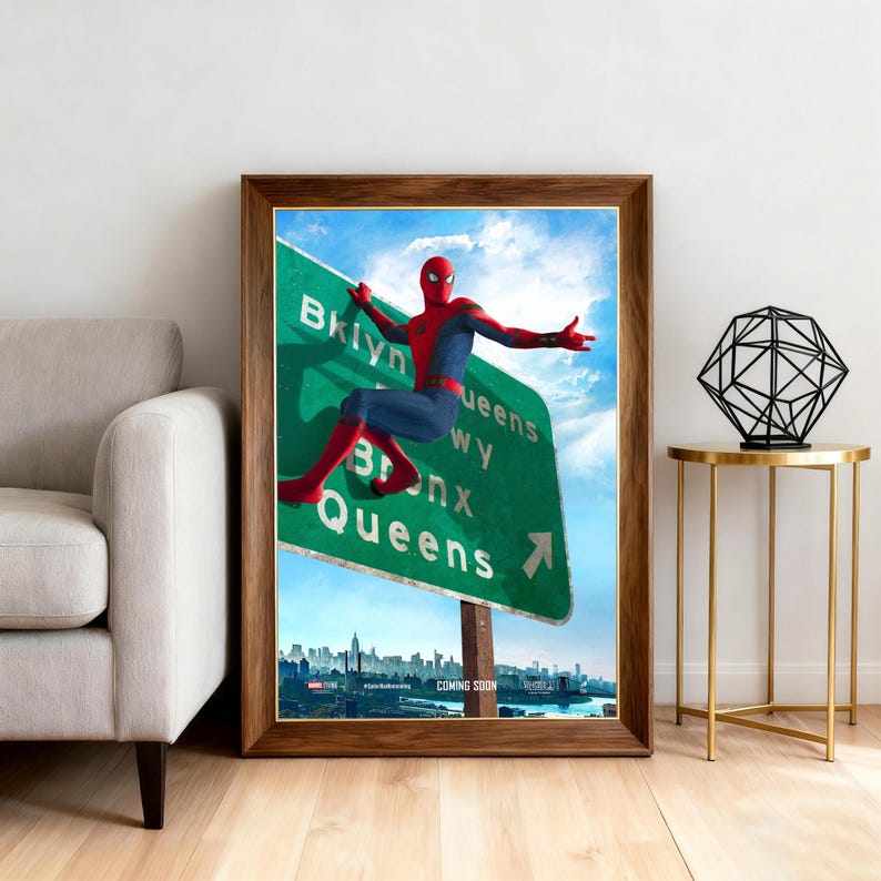 May include: Framed artwork featuring Spider-Man on a green highway sign pointing towards Brooklyn, Queens, and Bronx. The artwork is set against a blue sky with a city skyline in the background. The words "COMING SOON" are visible.