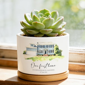 May include: A white ceramic planter with a wooden base containing a green succulent. The planter features a watercolor illustration of a two-story house with the text "Our first home", "4114 SEPULVEDA BLVD, CALIFORNIA", and "12th June 2026".