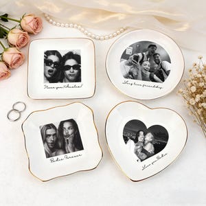 May include: Four white ceramic trinket dishes with gold rims, each featuring a black and white photo. The dishes are square, round, and heart-shaped, with handwritten text: "I love you Amelia!", "Long live friendship", and "Bestie Forever".