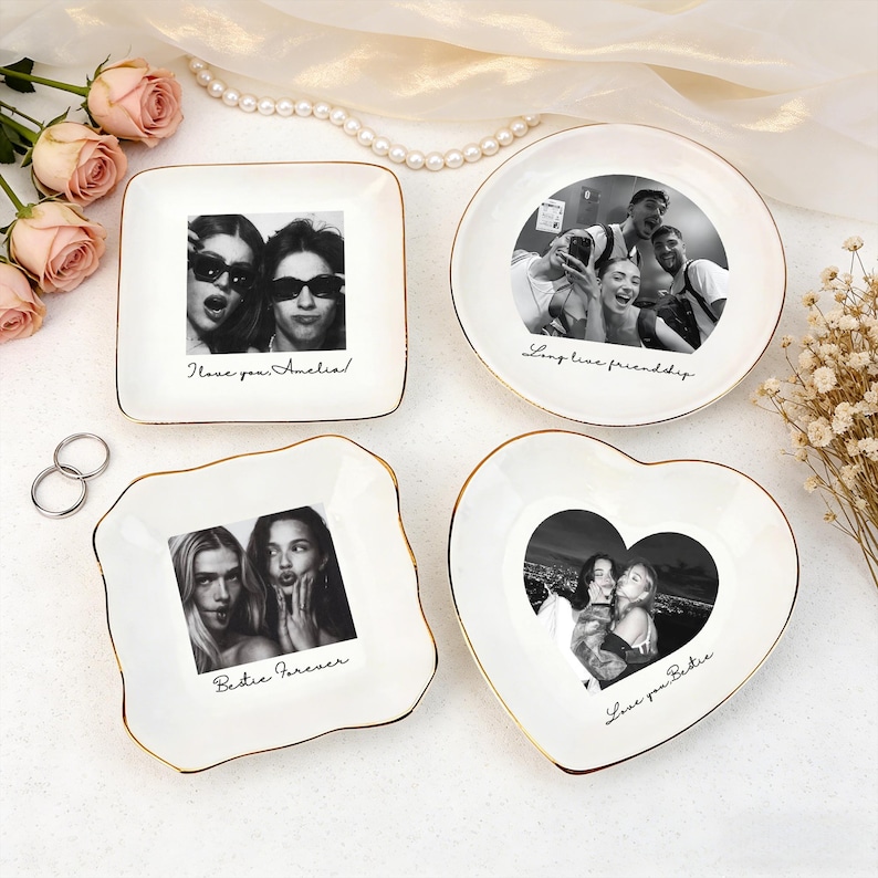 May include: Four white ceramic trinket dishes with gold rims, each featuring a black and white photo. The dishes are square, round, and heart-shaped, with handwritten text: "I love you Amelia!", "Long live friendship", and "Bestie Forever".