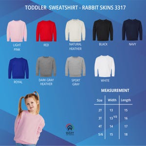 May include: A selection of toddler sweatshirts in various colors, including light pink, red, and navy. The image displays the color options and measurements for sizes 2T to 5/6. The text "TODDLER SWEATSHIRT - RABBIT SKINS 3317" is at the top.