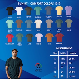 Op de afbeelding: Een verscheidenheid aan Comfort Colors 1717 t-shirts in verschillende kleuren, waaronder zwart, wit en blue jean. De afbeelding toont ook een maattabel met afmetingen in cm en het Ozzy Art Design logo.