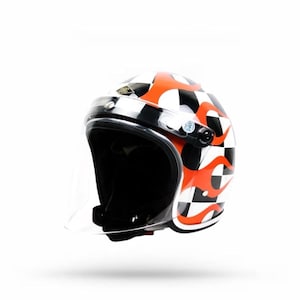 May include: A white motorcycle helmet with a clear visor, featuring a checkered pattern in black and white, and orange flame designs. The helmet has a black interior and trim.