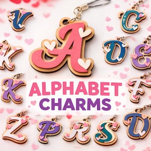 May include: Alphabet charms in various colors, including pink, blue, and purple, with heart accents. The charms are made of layered wood and feature the letters of the alphabet. The text "ALPHABET CHARMS" is displayed in pink and purple.