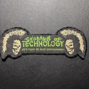 May include: Black patch with the text "CHILDREN OF TECHNOLOGY" in green, flanked by two skull-faced figures with mohawk-style hair. The text "IT'S TIME TO FACE THE DOOMSDAY" is below the main text.