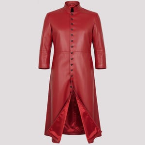 May include: A long, red leather coat with a mandarin collar and a button-down front. The coat has three-quarter sleeves and a split front, revealing a red satin lining. The coat is a solid colour and has a tailored fit.