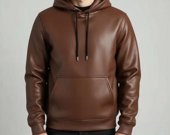 May include: A brown leather hoodie with a drawstring hood and a kangaroo pocket. The hoodie is a solid color and has a smooth texture. The sleeves are long and the cuffs are ribbed.