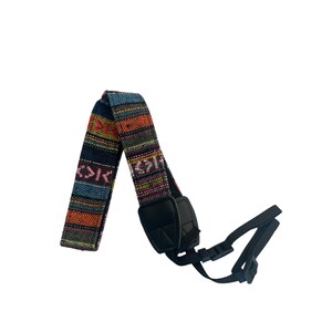 May include: A colorful camera strap with a woven pattern in shades of blue, orange, and red. The strap has a black leather pad and black adjustable buckles for attaching to a camera.