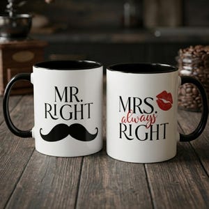 May include: Two white ceramic mugs with black handles and rims. One mug says "MR. RIGHT" with a black mustache graphic. The other mug says "MRS. always RIGHT" with a red lip print. The mugs are on a wooden surface.