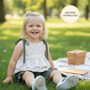 K&ouml;nnte beinhalten: Ein Kind tr&auml;gt ein cremefarbenes Oberteil mit floralem Muster und gr&uuml;ne Shorts und sitzt im Gras. Das Oberteil hat gr&uuml;ne Tr&auml;ger. Der Text "INSTANT DOWNLOAD" ist in einem Kreis enthalten. Ein Picknickkorb ist sichtbar.