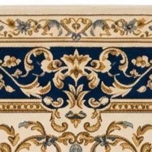 May include: A rectangular area rug featuring a deep navy blue center and border with an intricate cream and gold floral scrollwork pattern. The design includes symmetrical acanthus leaf motifs and delicate blossoms arranged in a classic border.