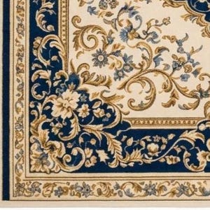 May include: A rectangular area rug featuring a cream-colored center with intricate blue and gold floral scrollwork. The border consists of a deep blue frame adorned with gold leaf patterns and a thin outer cream edge with small floral motifs.