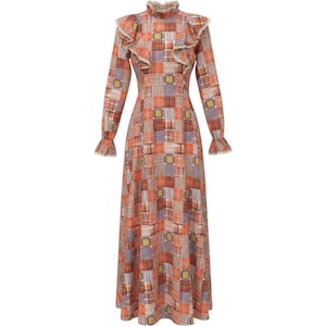 May include: A floor-length long-sleeve dress featuring a patchwork pattern of orange, brown, and purple plaid squares. The garment includes a high ruffled collar, ruffled shoulder details, and flared cuffs, all finished with a delicate lace trim.