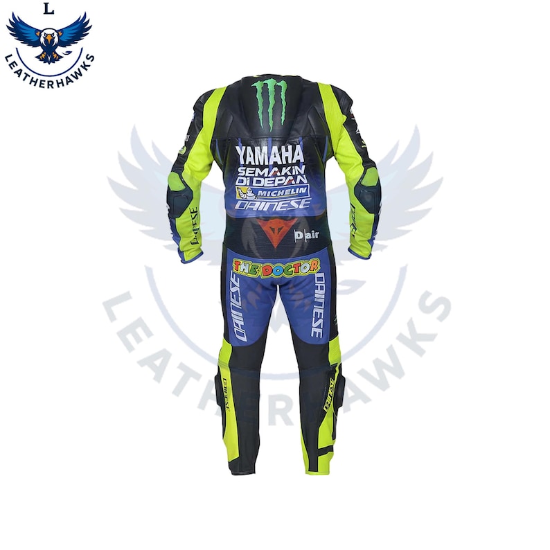 May include: A black, blue, and yellow Yamaha racing suit with the text "YAMAHA SEMAKIN DI DEPAN" and "THE DOCTOR" printed on it. The suit has Dainese and Michelin logos. The suit has elbow and knee protection.