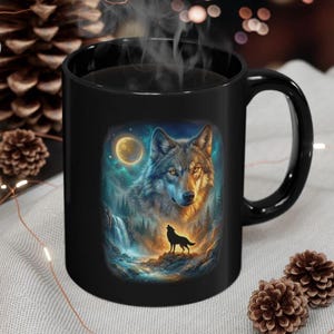 May include: Black ceramic mug with a detailed illustration of a wolf under a full moon. The artwork includes a waterfall and a silhouette of a howling wolf, set against a vibrant, colorful background.