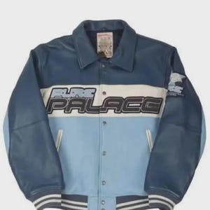 May include: A blue and light blue varsity jacket with the text "PALACE" across the chest. The jacket has a white stripe across the chest and sleeves, with a ribbed hem and cuffs. The jacket has a button-up front.