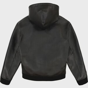 May include: Black leather jacket with a hood. The jacket has long sleeves and a black ribbed hem and cuffs. The back view shows the hood and the smooth texture of the leather. A classic outerwear piece.