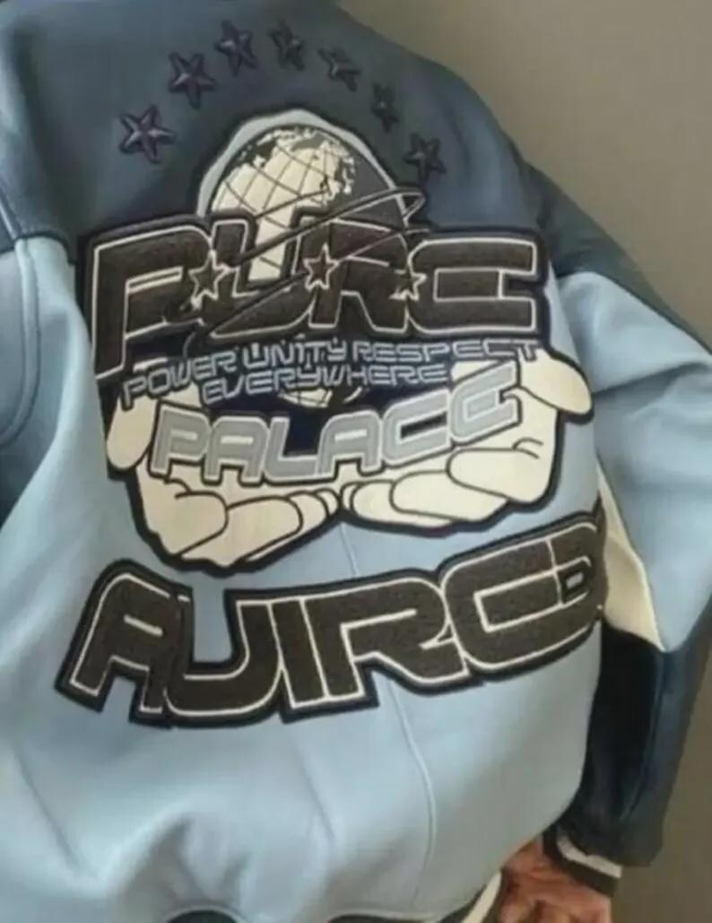 May include: A light blue and navy blue leather jacket with a large graphic on the back. The graphic includes the words "PURE PALACE" and "POWER UNITY RESPECT EVERYWHERE" in a stylized font, along with a globe and stars.