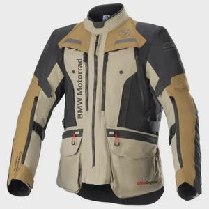 May include: A beige and black motorcycle jacket featuring a high collar, a full-length front zipper, and multiple pockets. The text BMW Motorrad is printed vertically on the chest, with BMW Drystar branding visible near the lower hem.