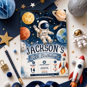 May include: A rectangular birthday invitation card featuring a watercolor space theme with an astronaut, planets, and a rocket. Text includes 'Jackson's 5th Birthday', 'Saturday June 14 2025', 'Jackson's Galaxy', '709 Starlight Drive', and 'RSVP to Lisa'.