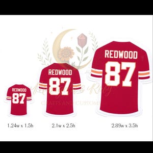 depicts sizing options of a red football jersey sticker with “REDWOOD 87,” inspired by Taylor Swift’s Life of a Showgirl “wood” song and Travis Kelce. Features white and yellow sleeve stripes and a glossy laminated finish.