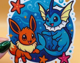 May include: A colorful sticker featuring two cartoon characters, an orange fox-like creature and a blue aquatic creature. The background is blue with white bubbles and orange and pink starfish. The sticker has a white border.