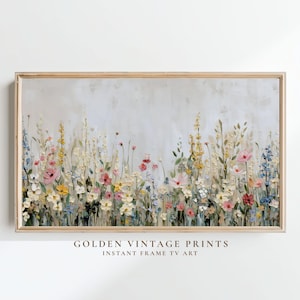 May include: A rectangular framed wall art print featuring a textured oil painting of a wildflower meadow with pink, yellow, and blue flowers against a neutral off-white background. The text GOLDEN VINTAGE PRINTS INSTANT FRAME TV ART is below.