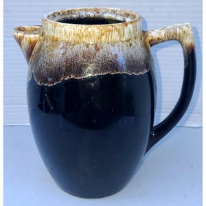 May include: A set of three ceramic mugs with a speckled, matte finish. The mugs are in shades of cream, light gray, and dark gray. Each mug has a simple, minimalist design, perfect for coffee or tea.