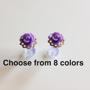 May include: A pair of purple rose earrings with gold accents. Choose from 8 colours.