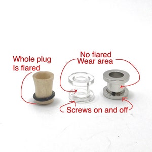 May include: Three different ear plugs are displayed. One is made of light wood with a flared design, another is clear acrylic, and the third is silver-colored metal. The acrylic plug screws on and off, while the metal one has no flared wear area.